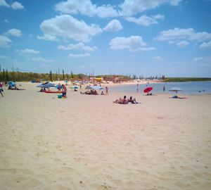 People on beach against sky