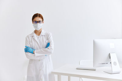 Portrait of woman standing against white background