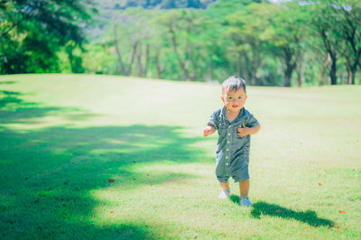 Full length of cute girl standing on field