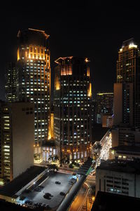 High angle view of illuminated cityscape against sky at night