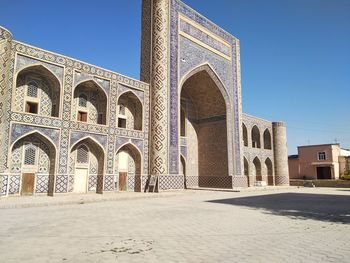 Low angle view of historical building against clear blue sky