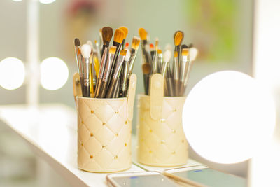 Close-up of make-up brushes on table