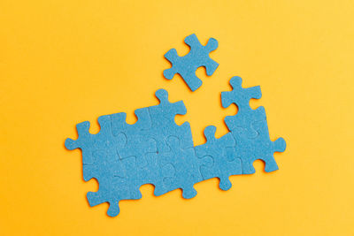 High angle view of toy on yellow background