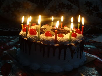 Burning candles on birthday cake