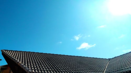 Low angle view of roof against blue sky
