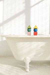 Stacks of toy blocks standing on bathtub rim