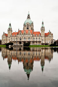 Lake in front of new town hall against sky