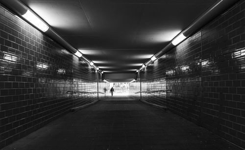 Rear view of people walking in subway