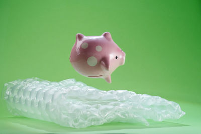 Close-up of stuffed toy over green background