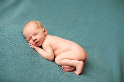 Cute baby boy lying on sofa