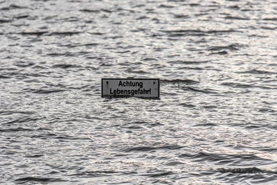 Close-up of text on sea