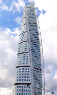 Low angle view of tower against cloudy sky