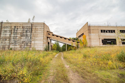 Low angle view of abandoned building against sky