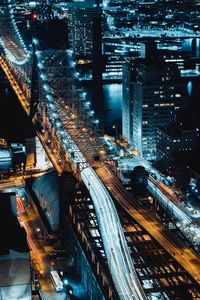 High angle view of city lit up at night