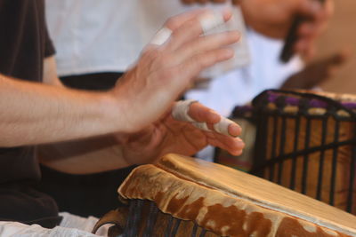 Close-up of man playing piano