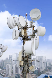 Low angle view of communications tower against sky