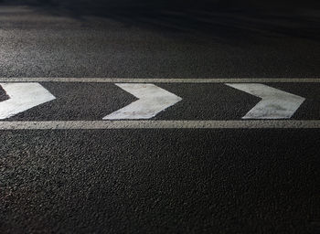 High angle view of arrow symbol on road in city