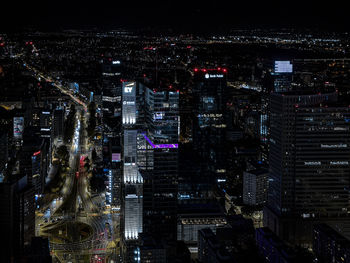 High angle view of illuminated buildings in city at night