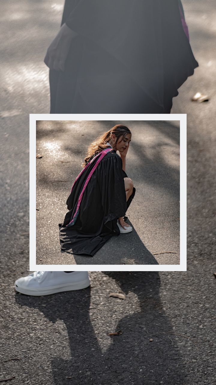 WOMAN SITTING ON STREET