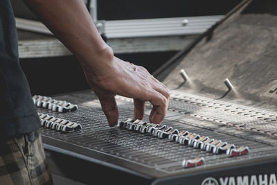 Cropped image of man using sound mixer in studio