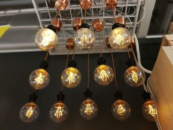 Low angle view of illuminated light bulb hanging