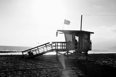 Lifeguard hut on beach against clear sky