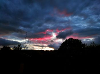 Low angle view of silhouette trees against sky at sunset