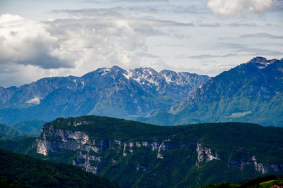 Spring snow melts on the peaks of the alps vicenza, veneto, italy