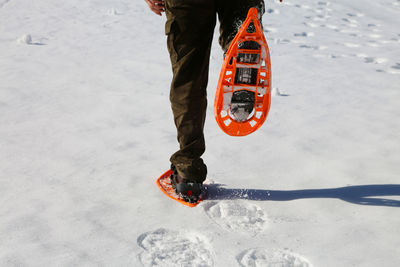 Low section of man on beach during winter