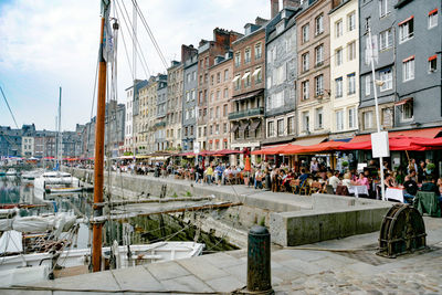 People on street amidst buildings in city