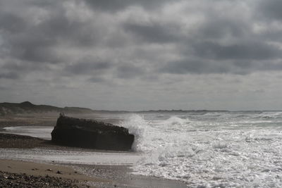 Scenic view of sea against cloudy sky