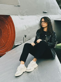 Low angle view of young woman sitting on airport