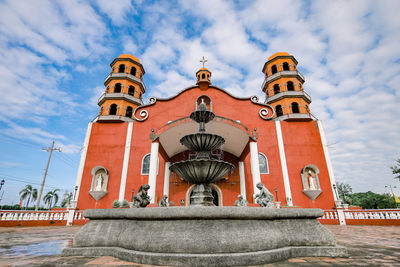 Low angle view of building against cloudy sky