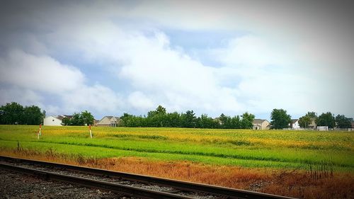 View of agricultural field against cloudy sky