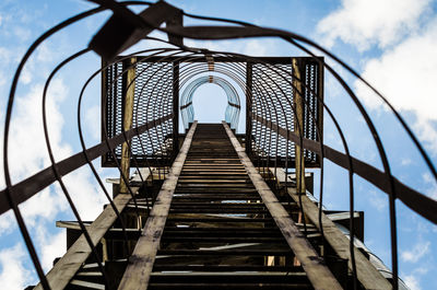 Directly below shot of ladder against sky