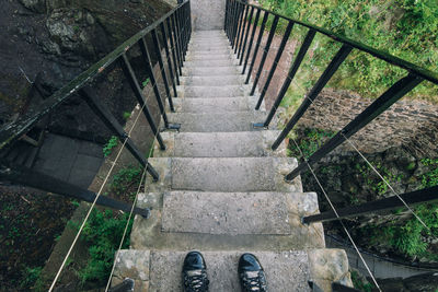 Low section of person standing on staircase