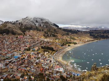 High angle view of lake titicaca and city against sky