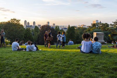 People relaxing on grassy field