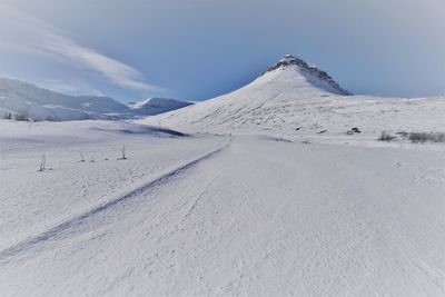 Scenic view of snowy landscape against sky