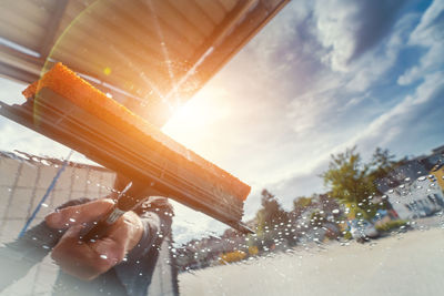 Man washing car seen through windshield