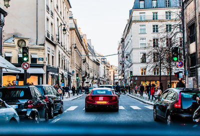 People and vehicles on street in city