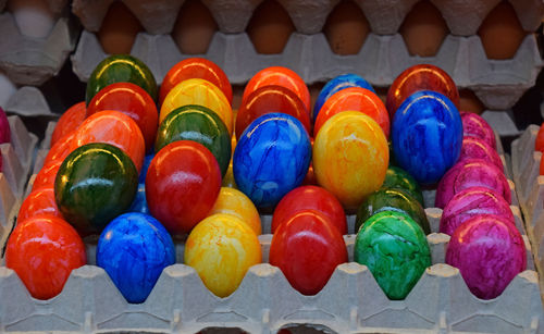 Close-up of colorful painted eggs in carton