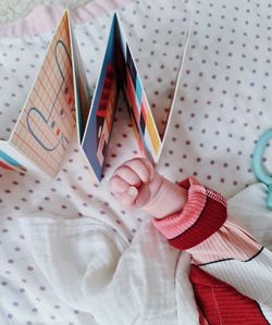Close-up of hand holding ice cream cone on table