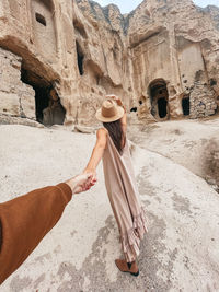 Rear view of woman standing on rock formations