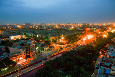 High angle view of illuminated city against clear sky at night