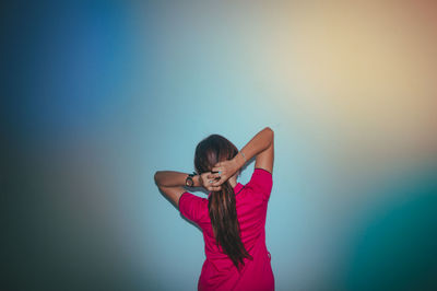 Woman standing against wall