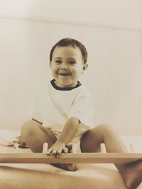 Portrait of cute boy sitting at home