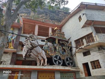 Low angle view of statue against building