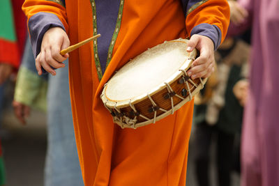 Midsection of person playing musical instrument