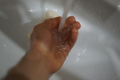 High angle view of person  in bathroom and washing hands